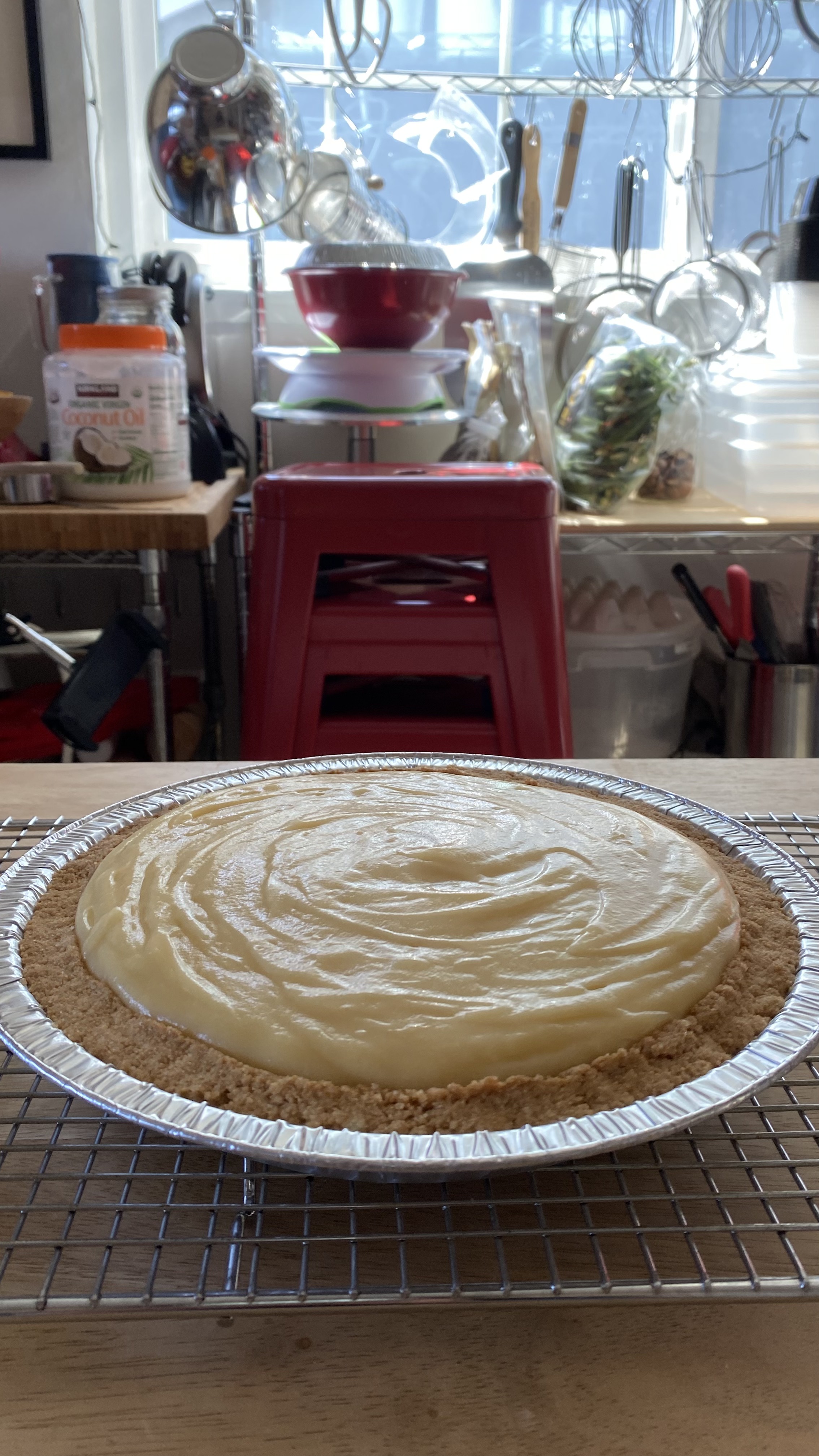 A small yellow pie with a soft center in a kitchen